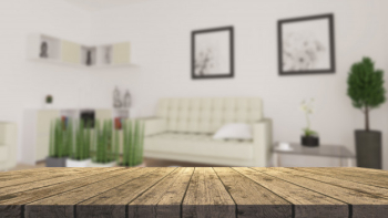 3d wooden table looking out to a defocussed modern living room