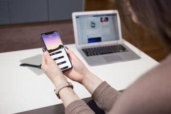A female holding an iPhone X A female holding an iPhone X