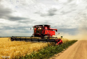 A harvesting combine kicks up dust during its.. | Free public domain photo - 434333