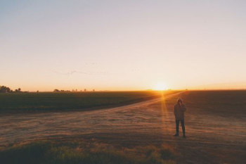 A man standing in Mexicali in desert during sunset A man standing in Mexicali in desert during sunset