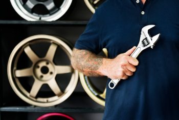 A mechanic holding a wrench A mechanic holding a wrench