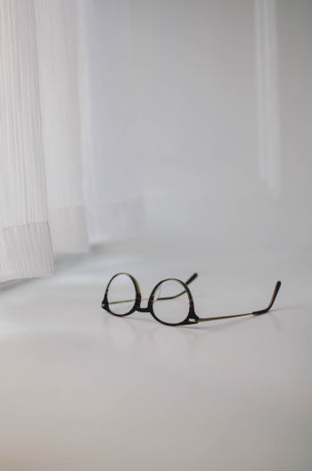A pair of Ace & Tate glasses on a window sill. A pair of Ace & Tate glasses on a window sill.