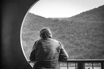 A person looking outside a window A person looking outside a window