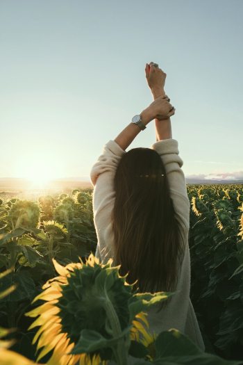 A woman facing the sunlight | Free Photo - rawpixel