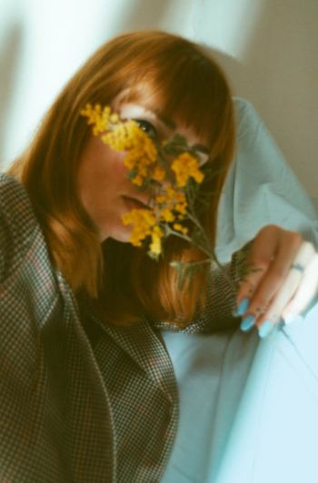 A Woman Holding a Yellow Flower