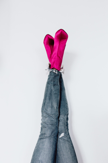 A woman in pink boots and blue jeans A woman in pink boots and blue jeans