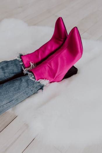 A woman in pink boots and blue jeans A woman in pink boots and blue jeans