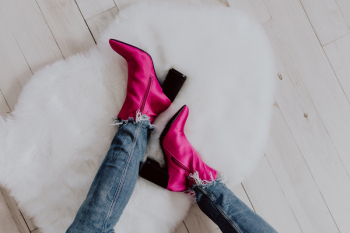 A woman in pink boots and blue jeans A woman in pink boots and blue jeans