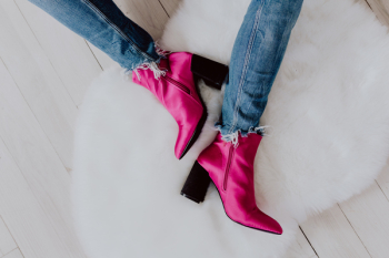 A woman in pink boots and blue jeans A woman in pink boots and blue jeans