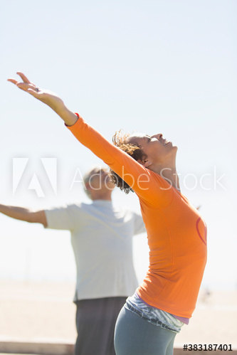 Active seniors practicing yoga outdoors
