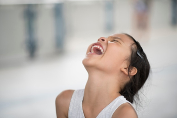 Adorable little girl laughing in the street Adorable little girl laughing in the street