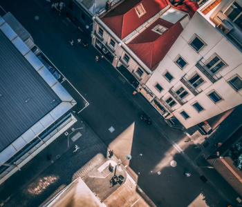 aerial photography of asphalt road between buildings aerial photography of asphalt road between buildings