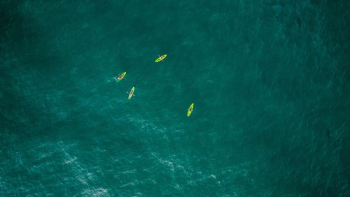 aerial photography of four green kayaks aerial photography of four green kayaks