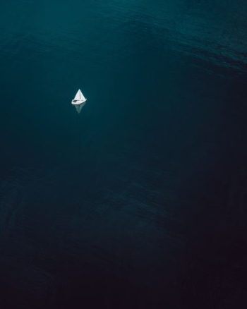 aerial photography of sailboat sailing on water body aerial photography of sailboat sailing on water body