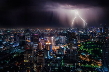 aerial view of city buildings with lightning strike aerial view of city buildings with lightning strike