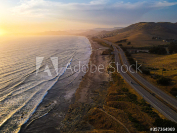 Aerial view of coastal road during sunset Aerial view of coastal road during sunset