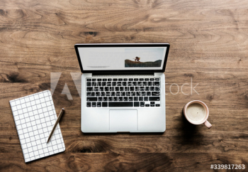 Aerial view of computer laptop on wooden table workspace concept Aerial view of computer laptop on wooden table workspace concept