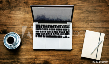 Aerial view of computer laptop on wooden table workspace concept Aerial view of computer laptop on wooden table workspace concept