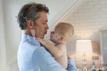 Affectionate father holding baby son Affectionate father holding baby son