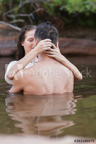 Affectionate sensual couple kissing in lake Affectionate sensual couple kissing in lake