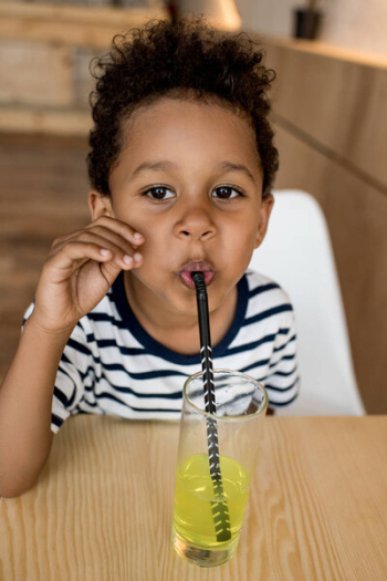 African american child drinking juice African american child drinking juice