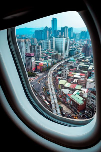 airplane window view of skyscraper airplane window view of skyscraper