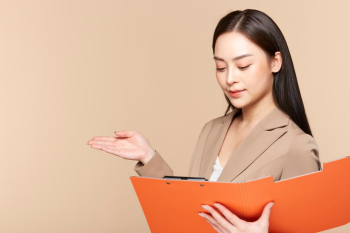 An active female office worker is holding documents and preparing to introduce her presentation