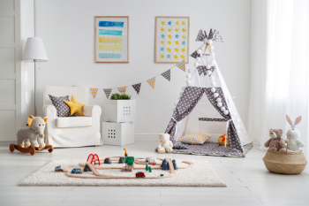 an empty children's playroom with tent and  toy railway