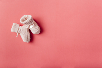 An overhead view of woolen baby's socks against bright background