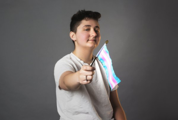 Androgynous Person Holds Trans Pride Flag Androgynous Person Holds Trans Pride Flag