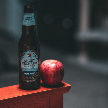 Angry Orchard Hard Cider Bottle Beside Red Apple Fruit Angry Orchard Hard Cider Bottle Beside Red Apple Fruit