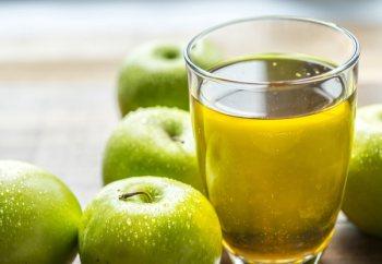 Apple Juice in Drinking Glass Beside Green Apples Apple Juice in Drinking Glass Beside Green Apples