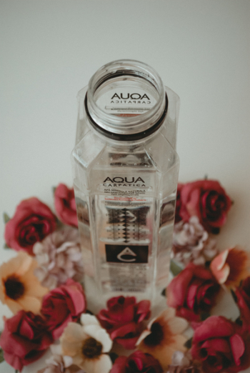 Aqua Bottle Surrounded by Flowers Aqua Bottle Surrounded by Flowers