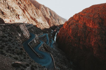 asphalt road beside mountains asphalt road beside mountains