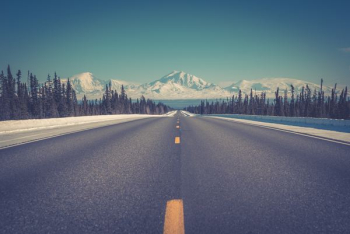 asphalt road between trees under blue clear sky during daytime asphalt road between trees under blue clear sky during daytime