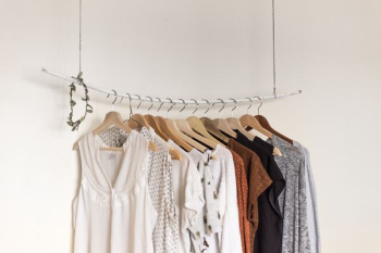 assorted clothes in wooden hangers assorted clothes in wooden hangers