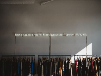assorted clothes lot on gray clothes racks assorted clothes lot on gray clothes racks