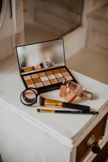 Assorted Cosmetic Products on White and Brown Wooden Drawer Cabinet Assorted Cosmetic Products on White and Brown Wooden Drawer Cabinet