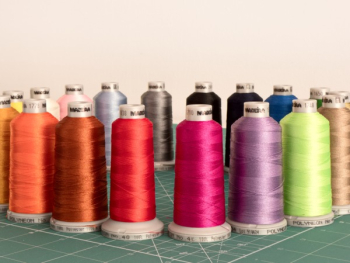 Assorted Sewing Threads on Greensurface