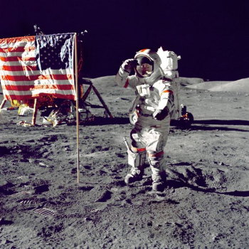 astronaut standing on moon beside U.S.A. flag astronaut standing on moon beside U.S.A. flag