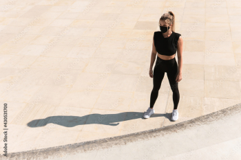 Athletic woman wearing face mask during summer street workout Athletic woman wearing face mask during summer street workout