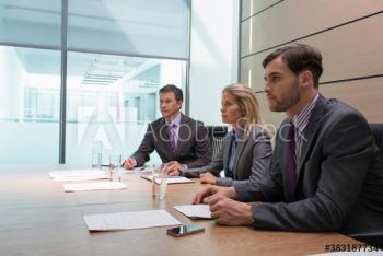 Attentive business people listening in conference room meeting
