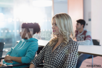 Attentive young female college student listening in classroom