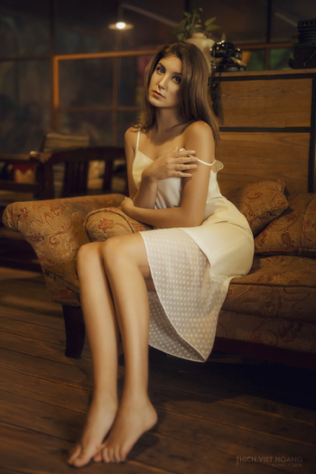 attractive girl sitting on sofa attractive girl sitting on sofa