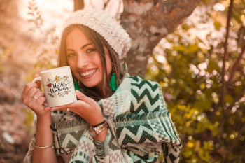 Autumn concept with woman holding mug