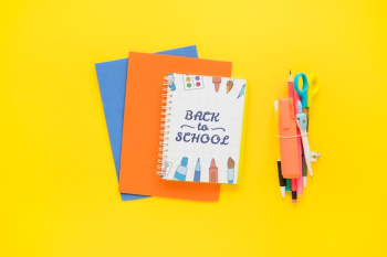 Back to school mockup with notebook cover on papers
