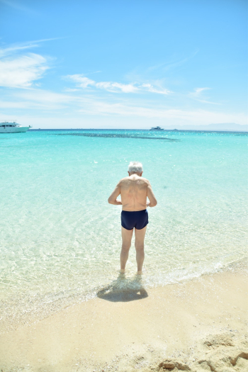 Back View of an Elderly Person on the Beach Back View of an Elderly Person on the Beach