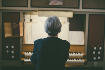 Back View of Woman Playing Organ Back View of Woman Playing Organ