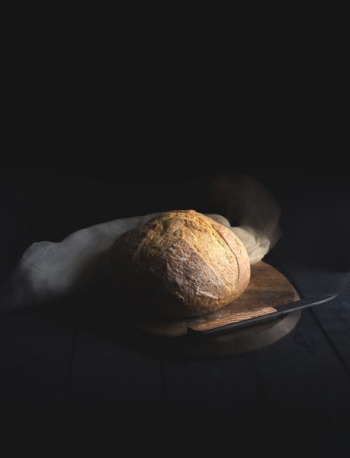 baked bread beside knife on wooden board baked bread beside knife on wooden board