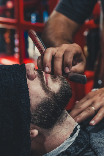 Barber shaving a mans beard Barber shaving a mans beard